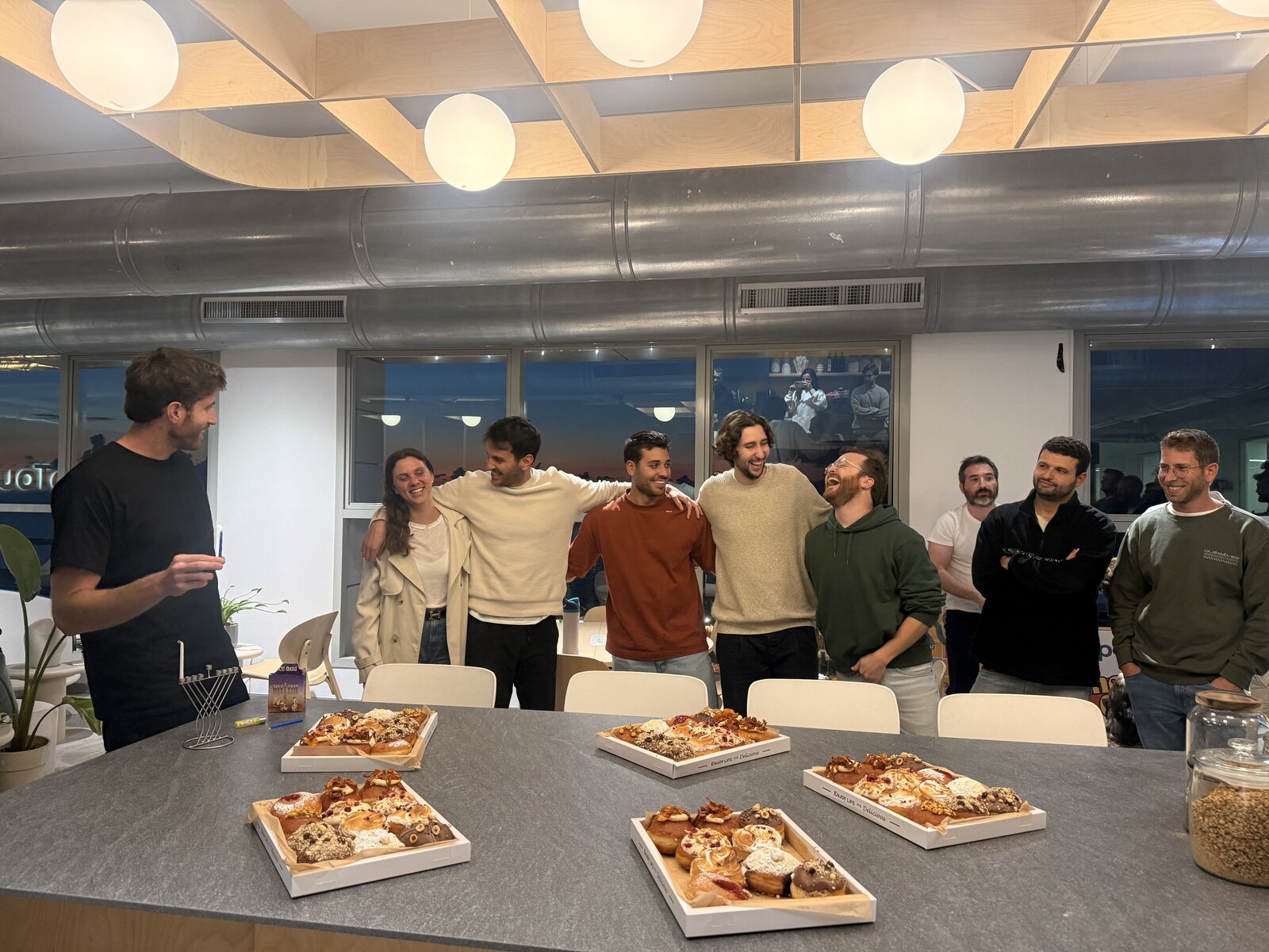 Team celebrating Hanukkah with sufganiyot